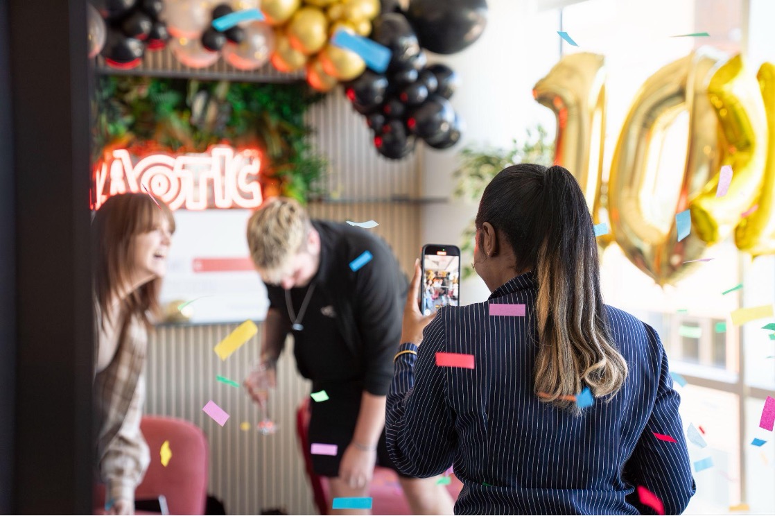 Confetti celebration in Chaotic HQ winner experience room with phone recording moment