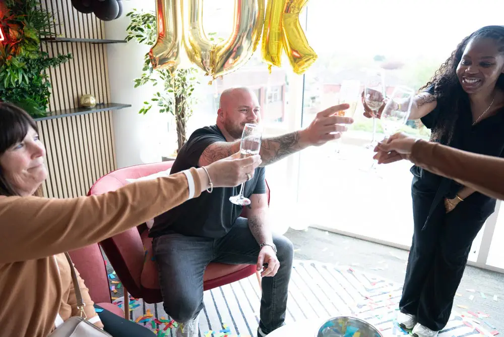 Josh doing a cheers with the Chaotic staff