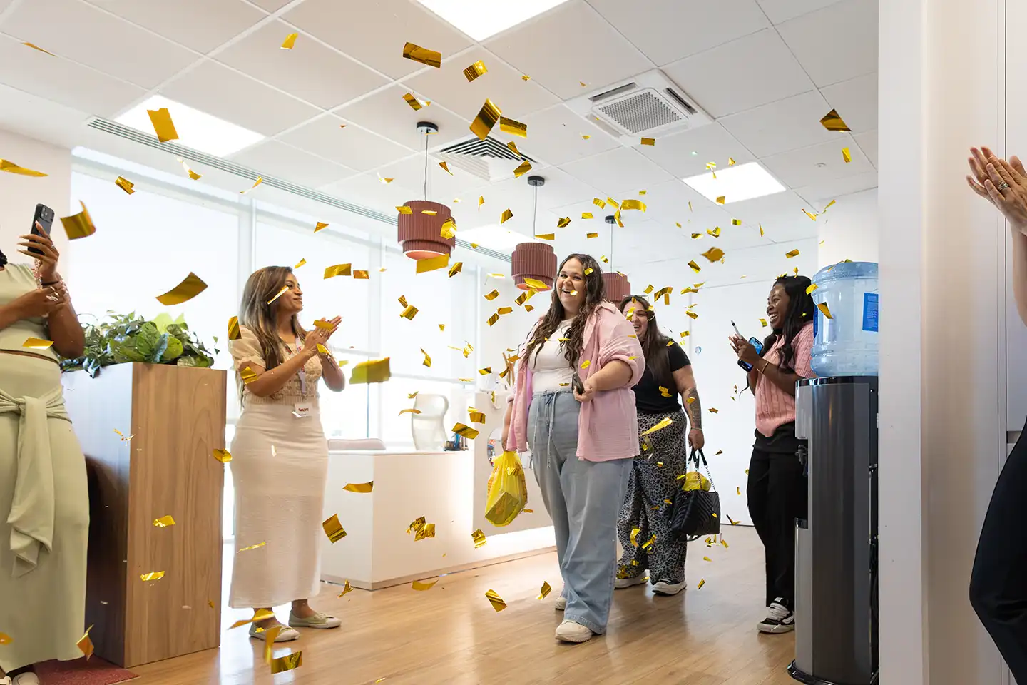 Michelle walking in to chaotic HQ with confetii all around her 